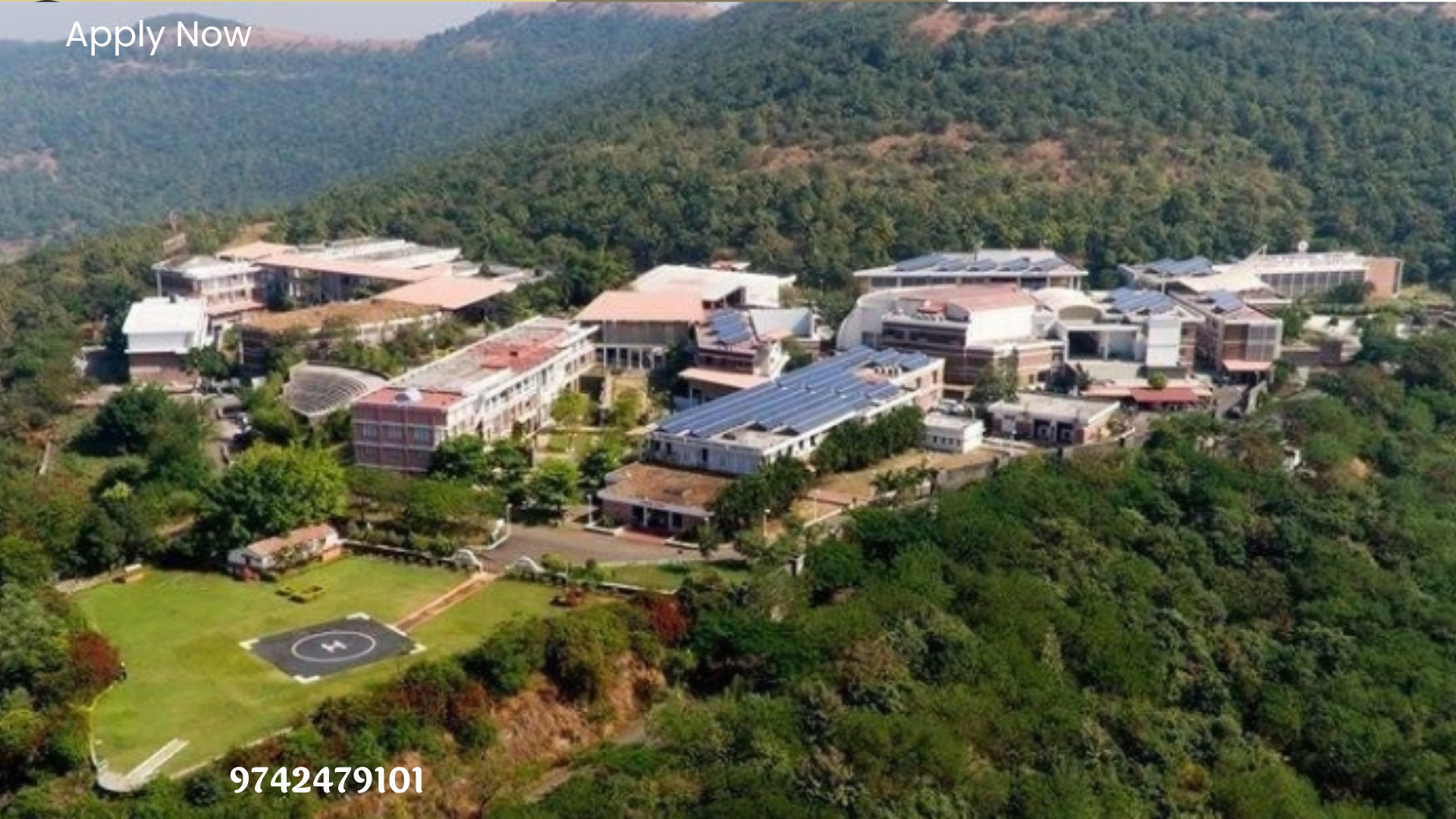 aerial view of a large building surrounded by trees