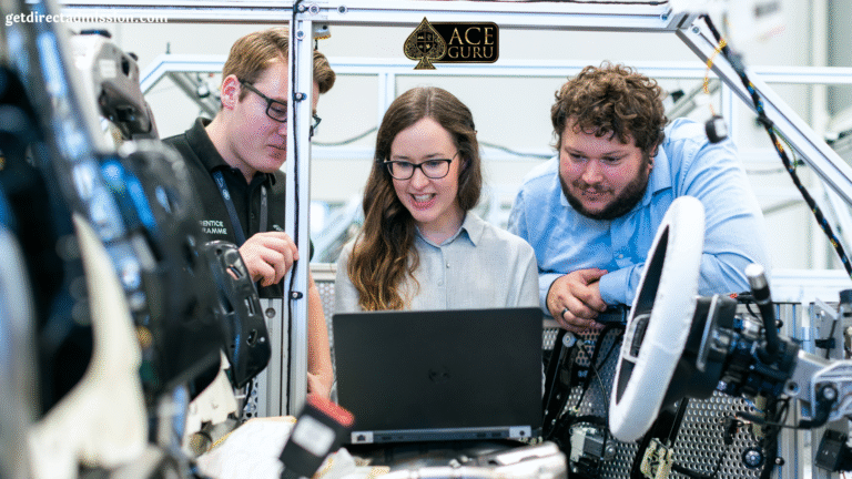 a group of people looking at a laptop