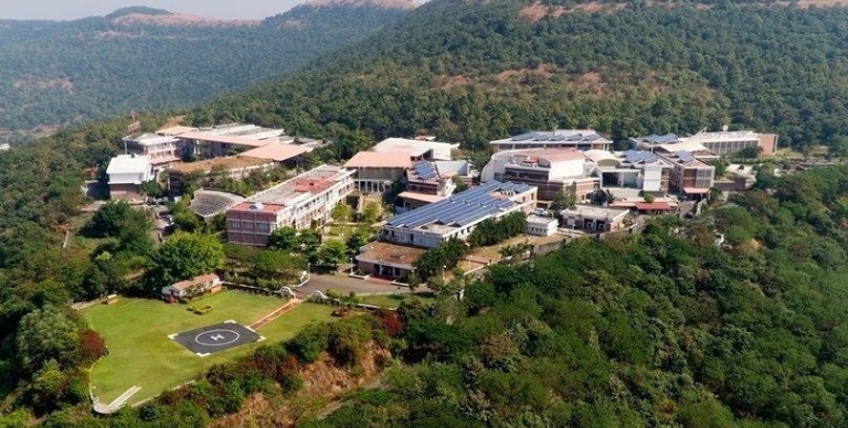 aerial view of a large building surrounded by trees